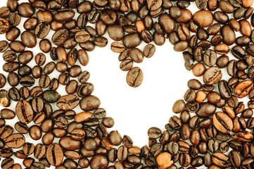 brown heart shaped texture background from roasted coffee beans can be used as template for design.