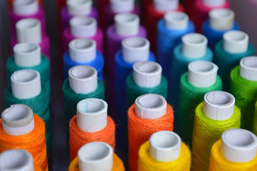 colourful thread rolls arranged in a box