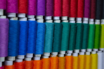 colourful thread rolls arranged in a box