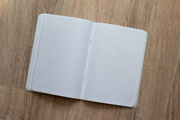 empty text book isolated on wooden background, template for planning, notes or diary, self development concept