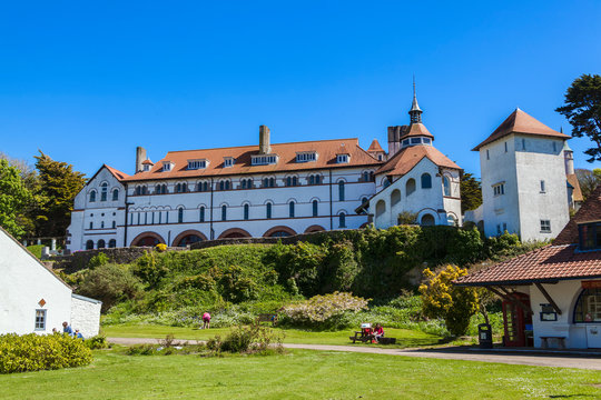 Caldey Island, Wales, UK, May, 14 2018: Caldey Abbey Tenby Pembrokeshire occupied by Cistercian monks which is a popular travel destination tourist attraction landmark of the town centre stock photo