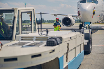 Ground crew preparing for towing an airplane