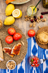 Traditional Majorcan food. Typical cuisine of the Balearic Islands. Picnic with fruit, almonds, pastries and sausages. Top view.