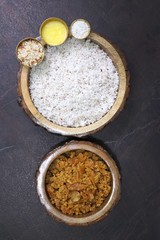 Ganesh Chaturthi special dish Modak. Indigents for Modak preparation. Grated coconut, Jaggery, Ghee or clarified butter, cardamom powder, and crushed almonds. Copy space.