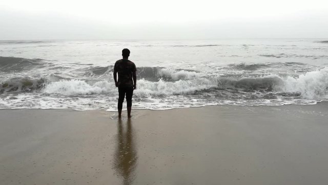 Lonely Indian Young Man Walking in the Beach