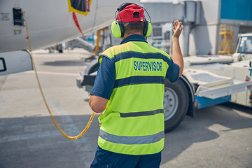 Male worker standing in front of the truck