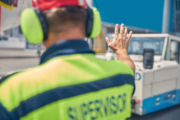 Man standing in front of an airplane tug