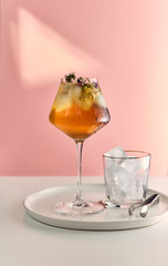Iced tea in a glass with ice and herbs