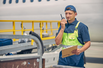 Man with a clipboard staring into the distance