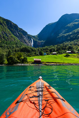 Red kayak in front of Norwegian scenery