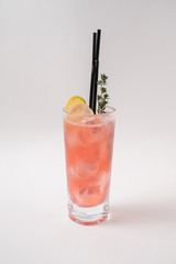 Making cocktails at home like an expert nightclub barman. Fresh and juicy colorful homemade cocktails garnished with berries, orange, mint and coffee on white background.