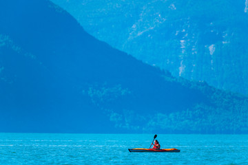 Fototapeta premium Woman sea kayaking in Norwegian fjord