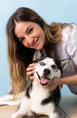 Naklejka na ściany i meble Veterinary doctor at vet clinic with Siberian Husky dog
