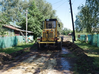 Fototapeta na wymiar construction work to repair the road. In the village. Dug-up road