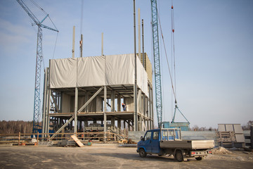 Fototapeta na wymiar Construction of a feed mill agro-processing plant for processing and silos for drying cleaning and storage of agricultural products, flour, cereals and grain. Bottom view.