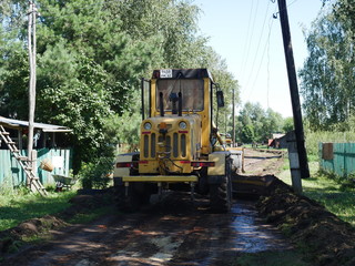 Fototapeta na wymiar construction work to repair the road. In the village. Dug-up road