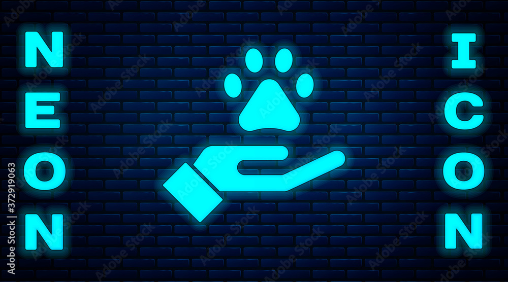 Poster glowing neon hands with animals footprint icon isolated on brick wall background. pet paw in heart. 