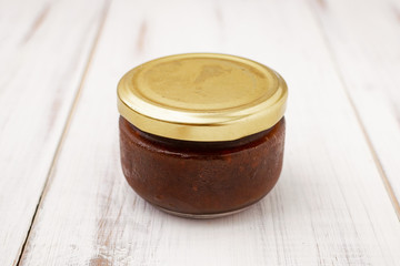 Product, vegetable pasta in a glass jar on a light wooden background.