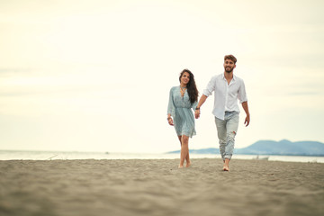 Young couple in love strolling the beach