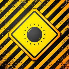Black Sun icon isolated on yellow background. Warning sign. Vector.