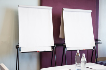 Papers realistic blank flipchart with legs on white paper background or roll up for presentation in meeting corporate training briefing or lecture classroom in university - obrazy, fototapety, plakaty