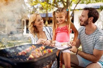 Family with his children prepare fire for family  barbeque.