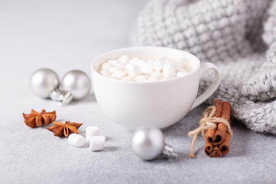 White cup with hot chocolate and marshmallow, sweater, cinnamon. Cozy christmas composition. Hygge concept Soft focus - Image