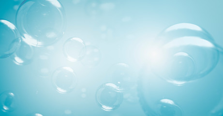 Freshing natural background. Transparent clear soap bubbles blur on a blue background.