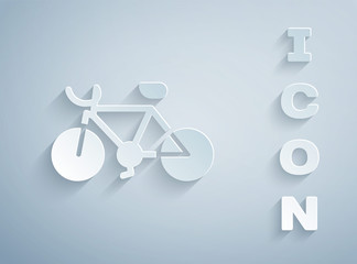 Paper cut Bicycle icon isolated on grey background. Bike race. Extreme sport. Sport equipment. Paper art style. Vector.