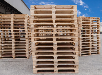 Stack of wooden pallets storage at manufacturing factory warehouse. 