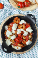 
Fried shrimp in a pan. Seafood salad. Tomatoes, soft cheese. Diet dish. Healthy eating. Mediterranean Kitchen
