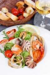 
Seafood salad. Mussels, shrimps, octopuses. Appetizing photo. Mediterranean Kitchen. Nice presentation. An exquisite dish. Close-up. Restaurant menu