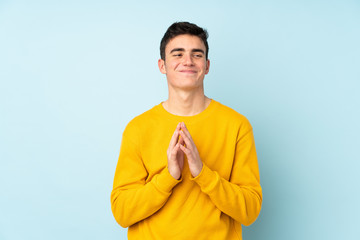 Teenager caucasian handsome man isolated on purple background scheming something