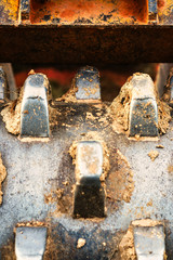 A closeup of the teeth on a large soil compactor.  