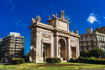 Obraz premium Porta del Mar, a square in the center of Valencia with a large stone construction, with saturated colors.
