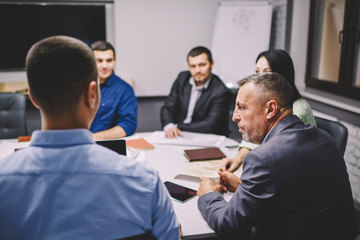 Business colleagues discussing productive strategy of solving problem.Group of male and female professionals with director of company talking about developing new project for entrepreneurship