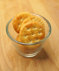 Stack of vanilla cream crackers in a mini glass bowl