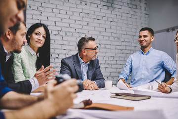 Group of successful business persons working together on common project while having brainstorming...