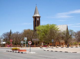 Otjiwarongo, Namibia: church surrounded by trees at the end of the dry season; the purple jacaranda...