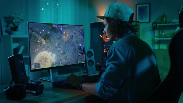 Professional eSports Gamer Plays RPG MOBA Mock-up Video Game with Modern Graphics ad Fun Gameplay on a Powerful Personal Computer. Cyber Gaming Stylish Retro Neon Room