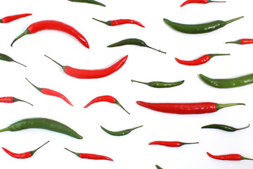 Green And Red Chilies Arranged Over White Background