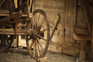 Fototapeta na wymiar Old Wagon Wheel in a Barn