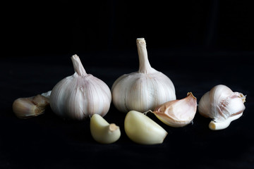 Raw Garlic On Black Background