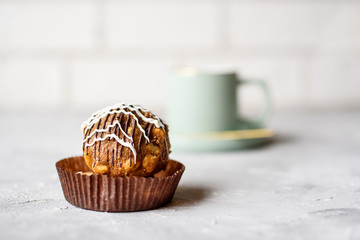 Fragrant tea in a beautiful cup in a light tone. Delicious cake with cream, and sand dough. Concrete background.