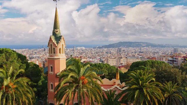View of Barcelona on a sunny day from Park Guell. Barcelona cityscape. Palm trees sway in the wind. Barcelona, Spain