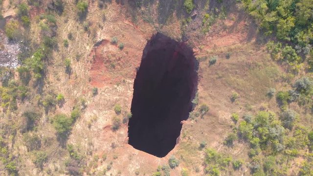 Sinkhole nature aerial aerial drone top bird eye view rotation camera movement Krivoy Rog Ukraine
