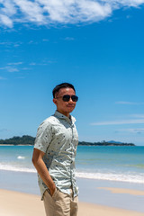 young man on a sunglasses in a beautiful beach