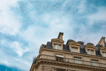 Typical old Paris architecture, facades of residential buildings with balconies and mansards