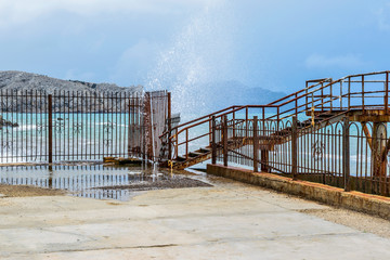 Metal grates and stairs on a concrete sea pier