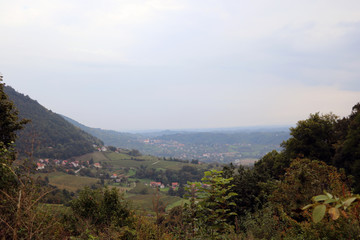 Mountain green meadows in a foggy morning.